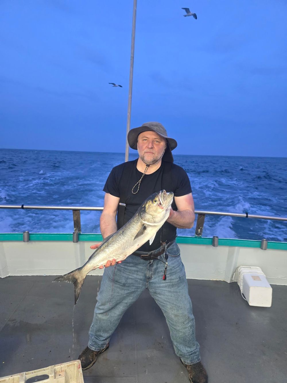 a man holding a fish in the water