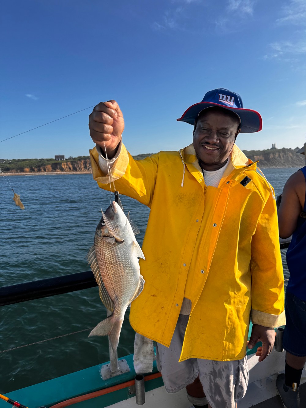 a person holding a fish in the water