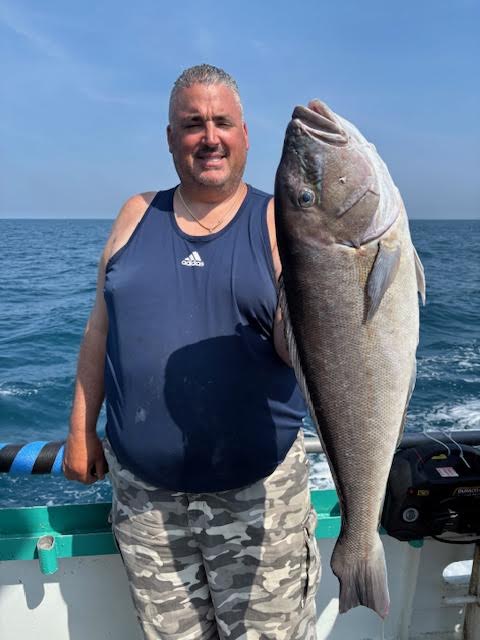 a person holding a fish in the water