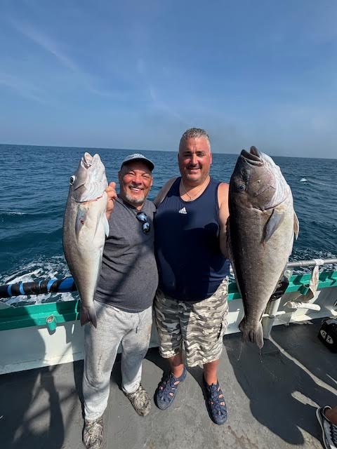 a person holding a fish in the water