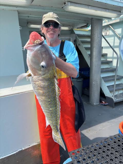 a man holding a fish