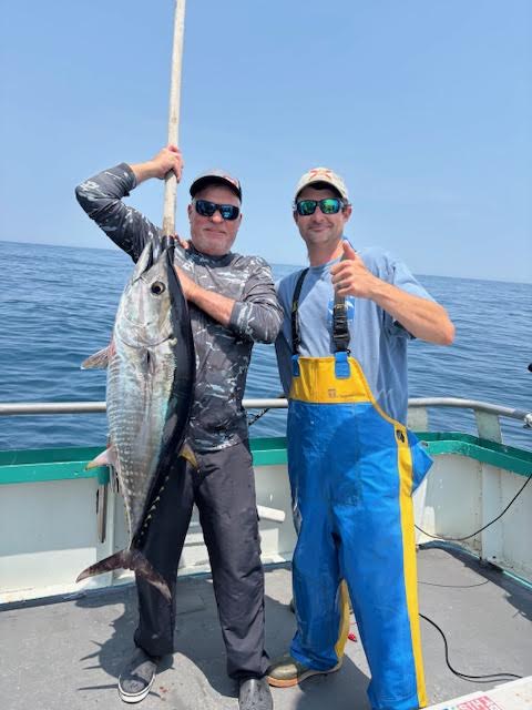 a man holding a fish in the water