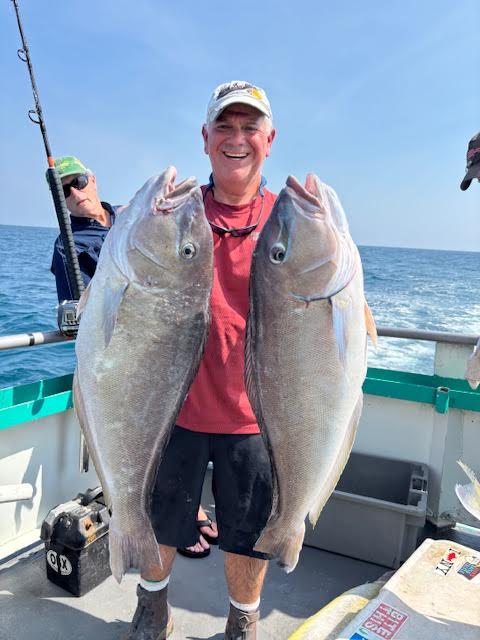 a man holding a fish in the water