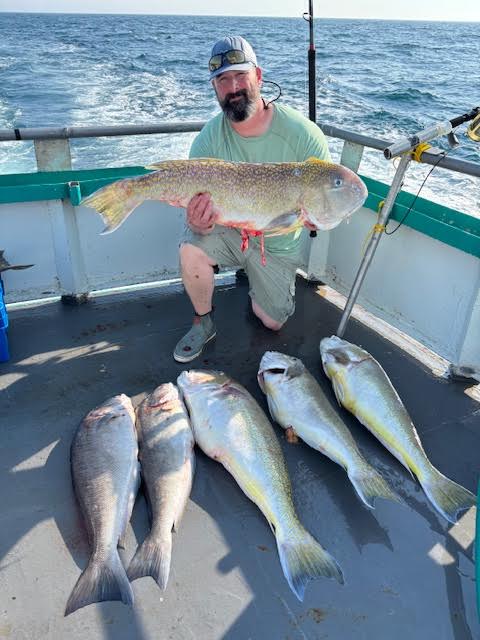 a person holding a fish in the water