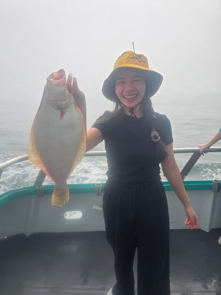 Yukie Nakayama holding a fish in the water