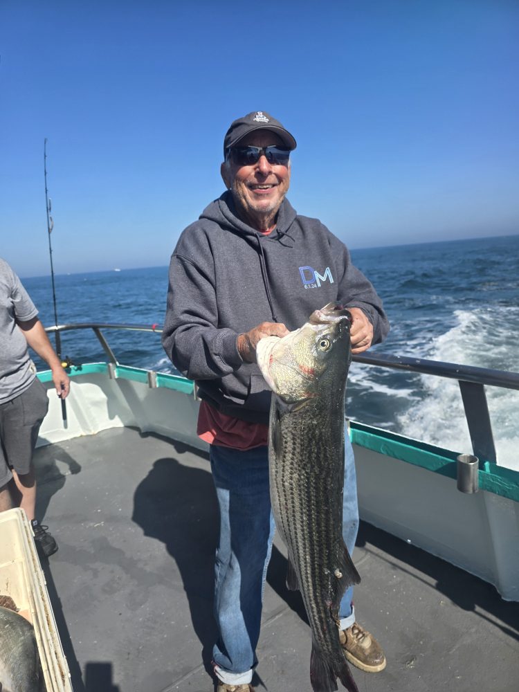a man holding a fish in the water