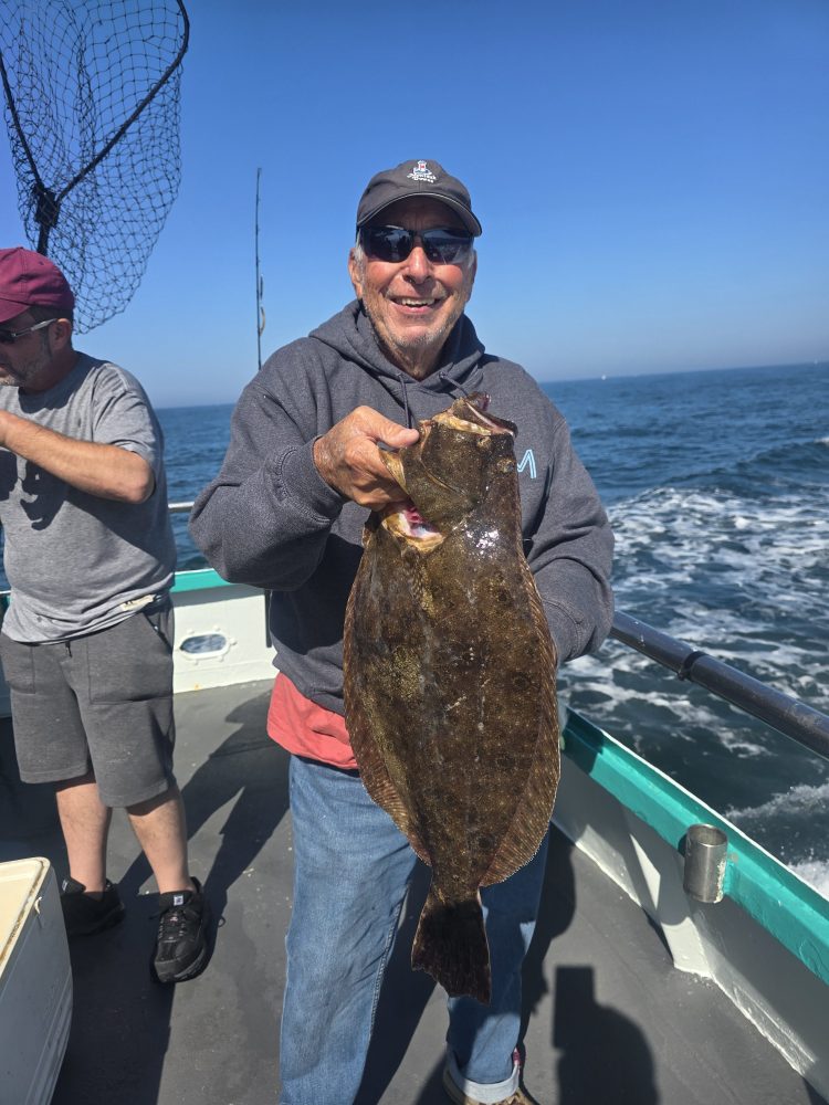 a man holding a fish in the water