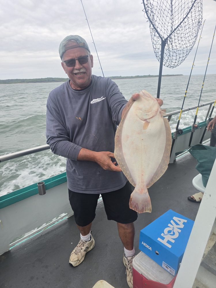 a man holding a fish in the water