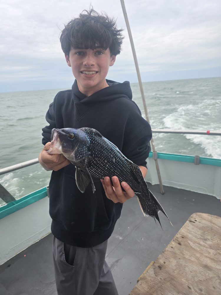 a person holding a fish in the water