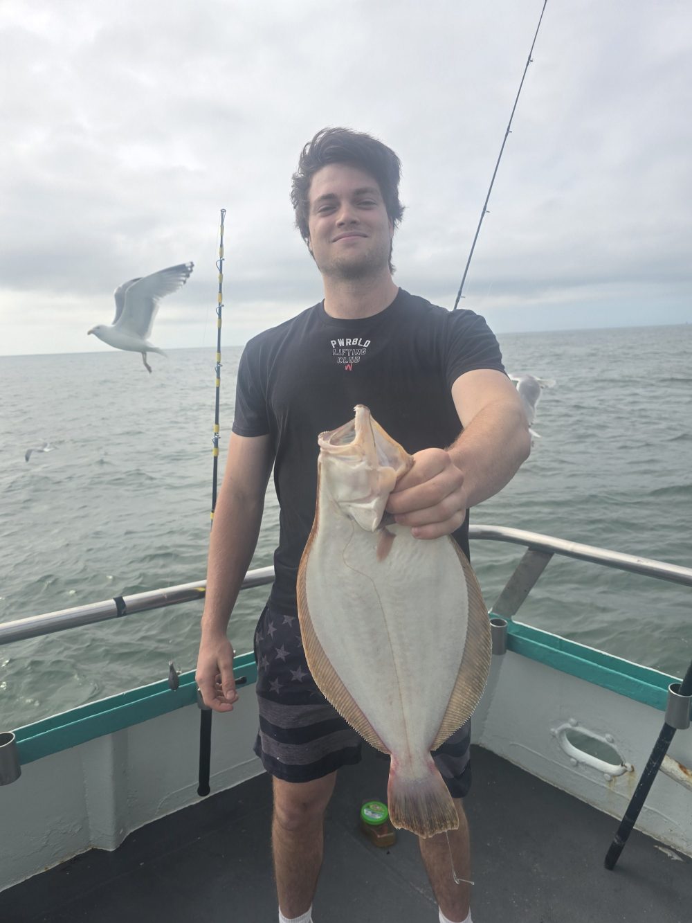 a man standing next to a body of water