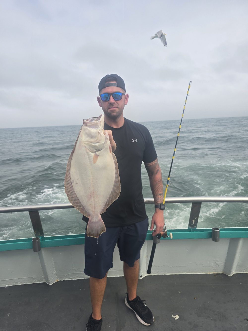 a man holding a fish in the water