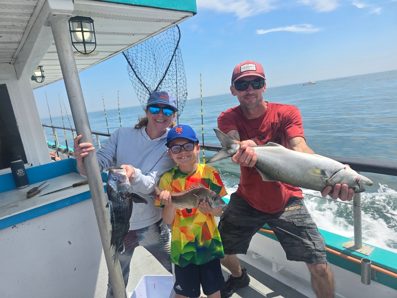a person holding a fish on a boat in the water