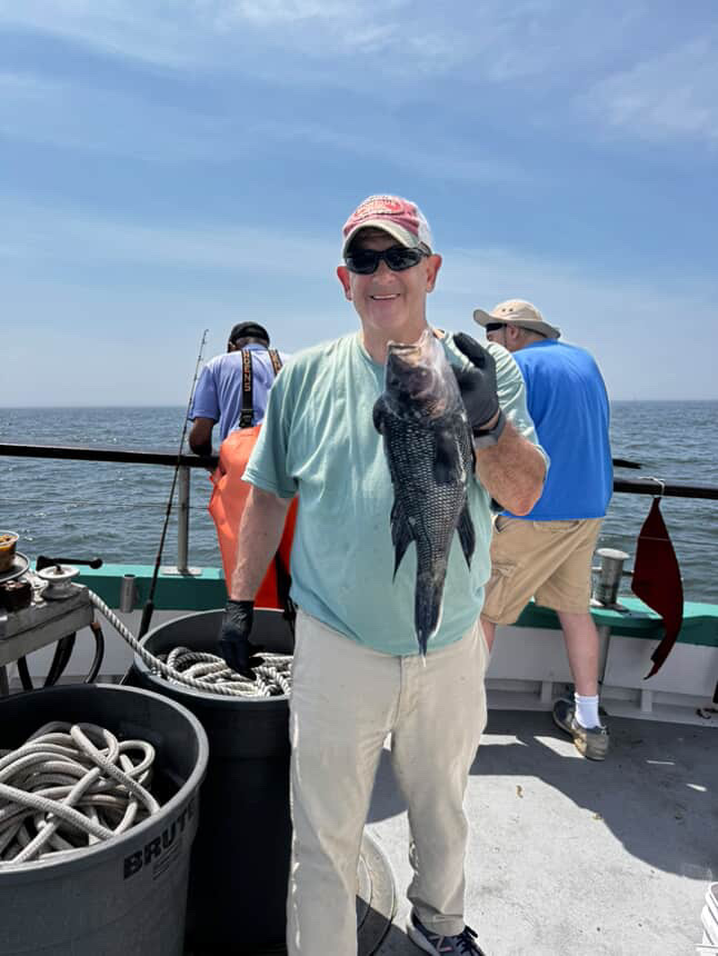 a group of people standing on a boat in the water