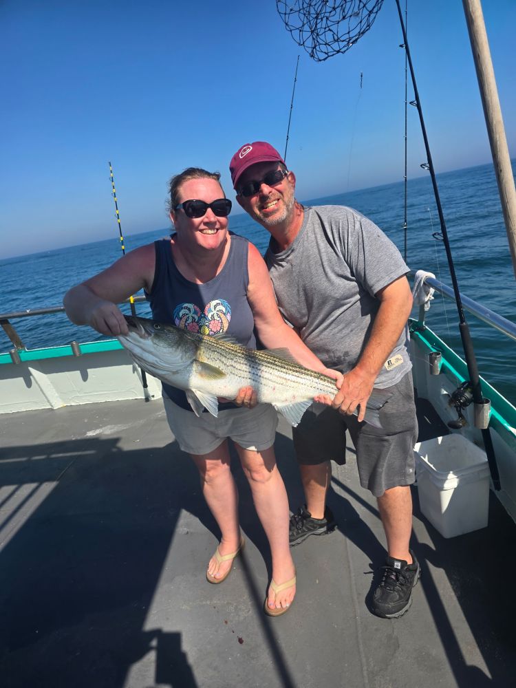 a person holding a fish in the water