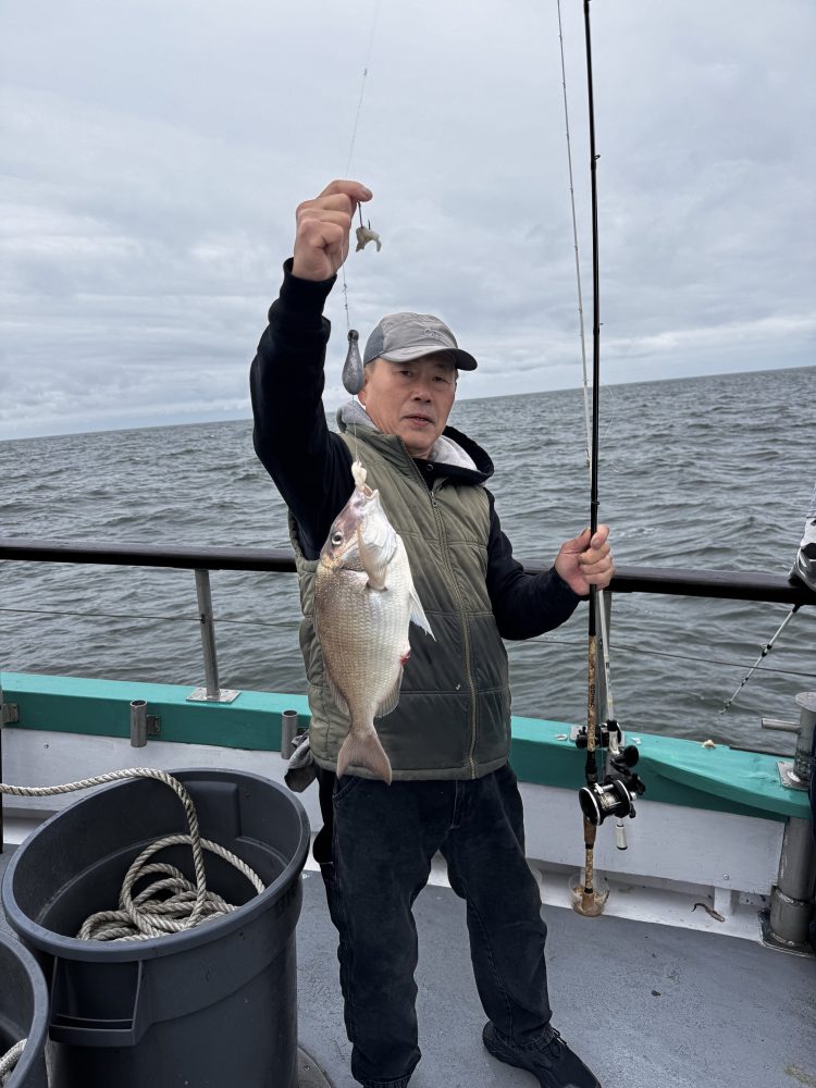 a man and a woman standing next to a body of water