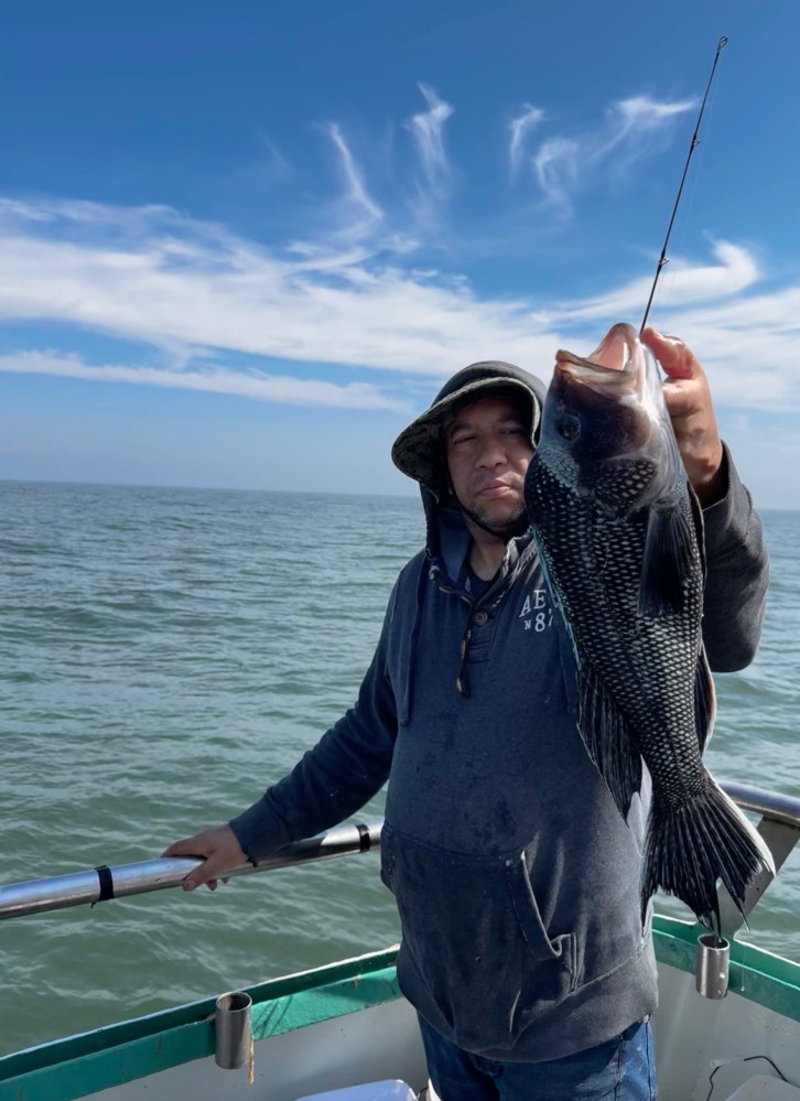 a person standing next to a body of water