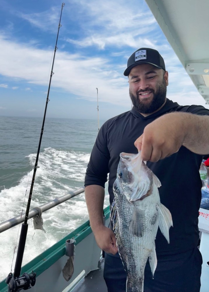 Matt Kemp holding a fish in the water