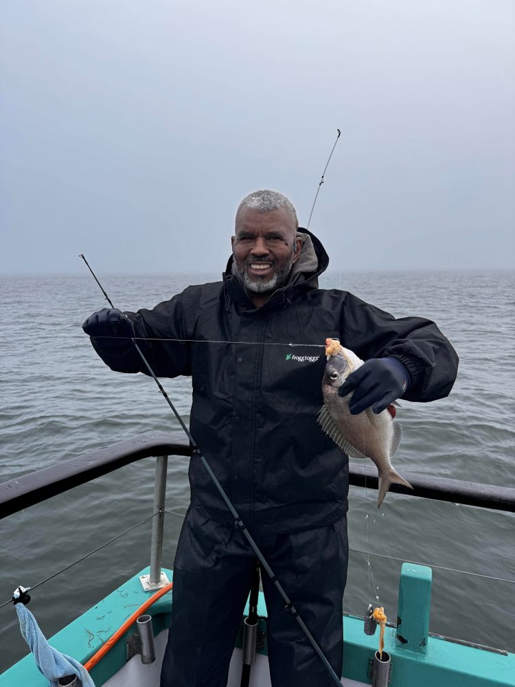 a person standing next to a body of water