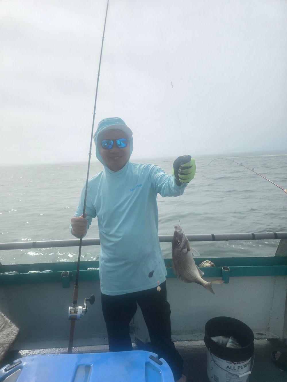 a man holding a fish in the water