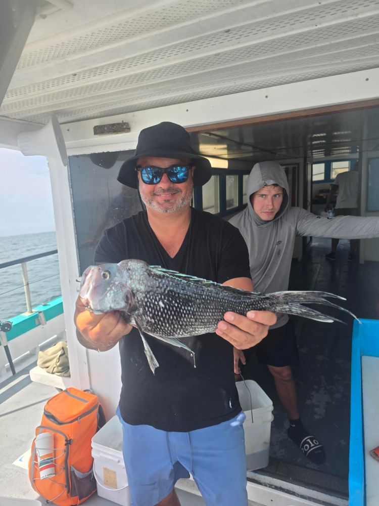 a man holding a fish