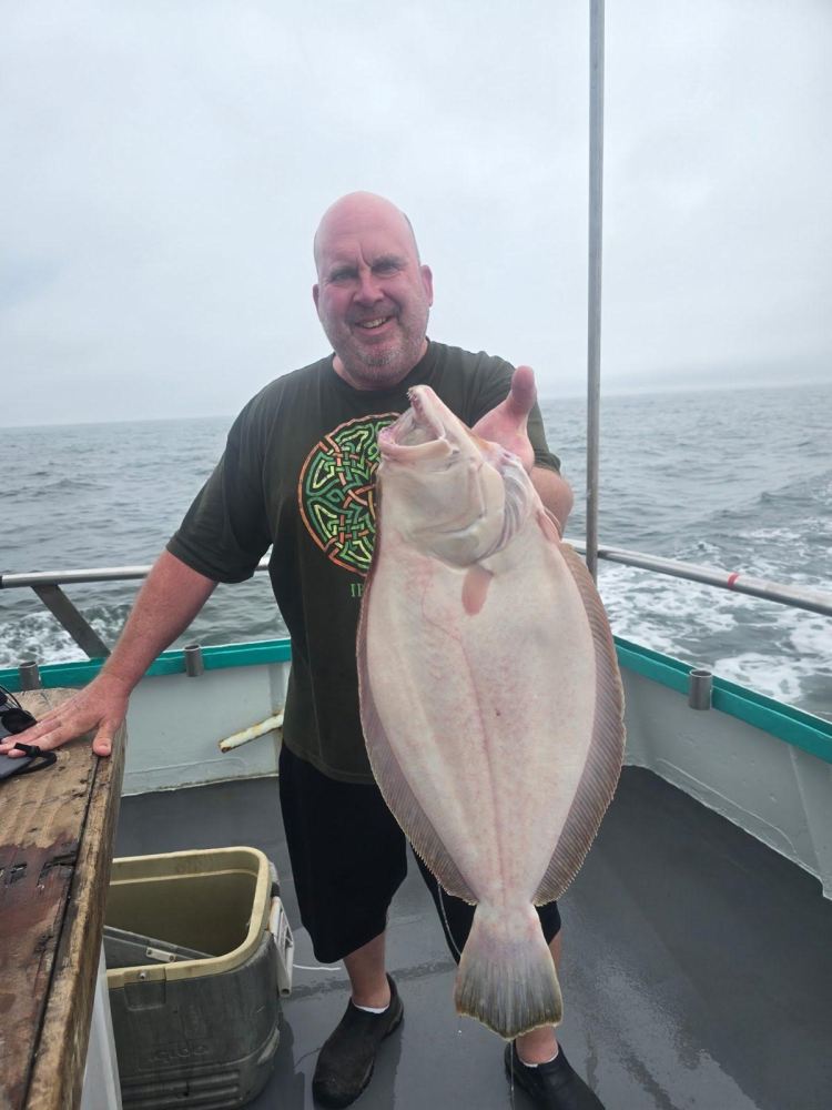 a man holding a fish in the water