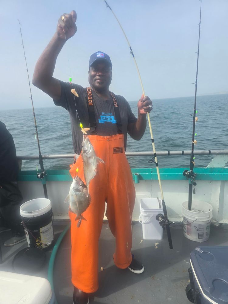 a person standing next to a body of water