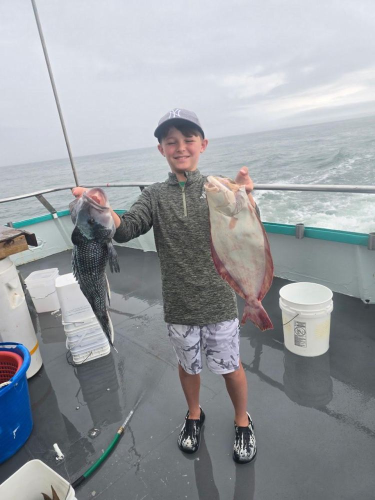 a man holding a fish in the water