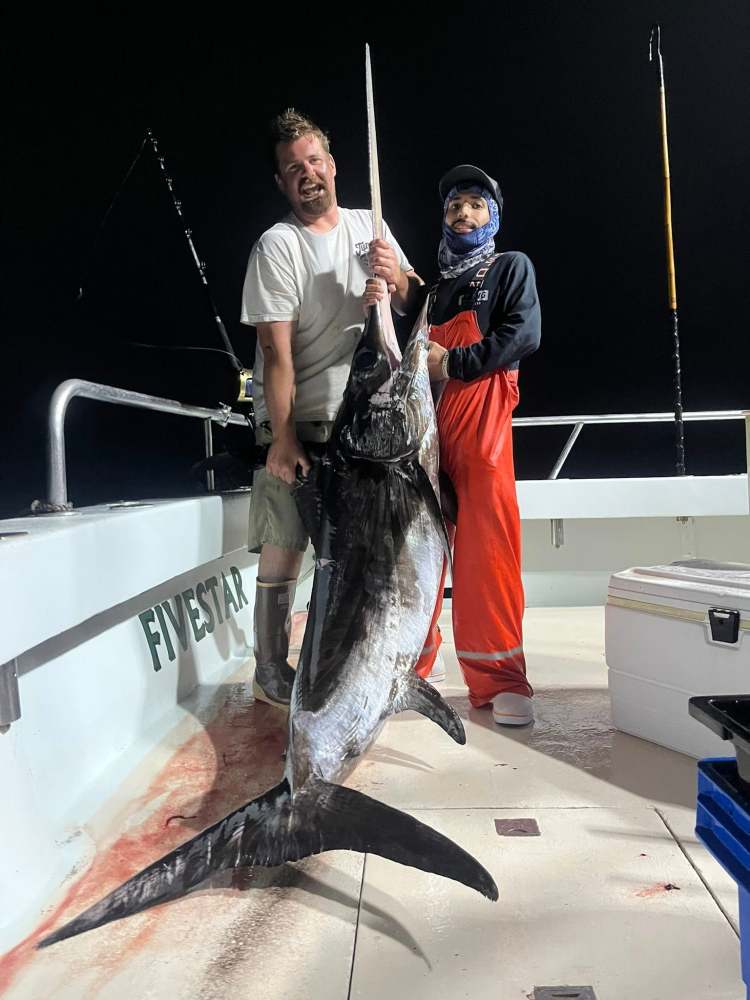 a man holding a fish
