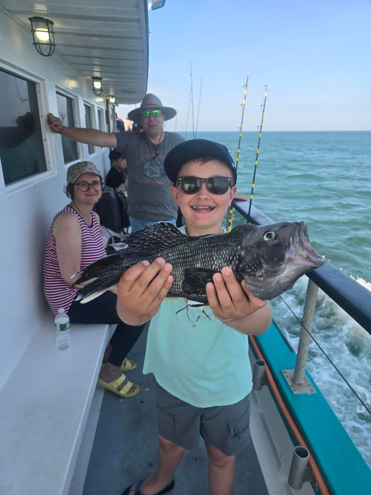 a man holding a fish in the water