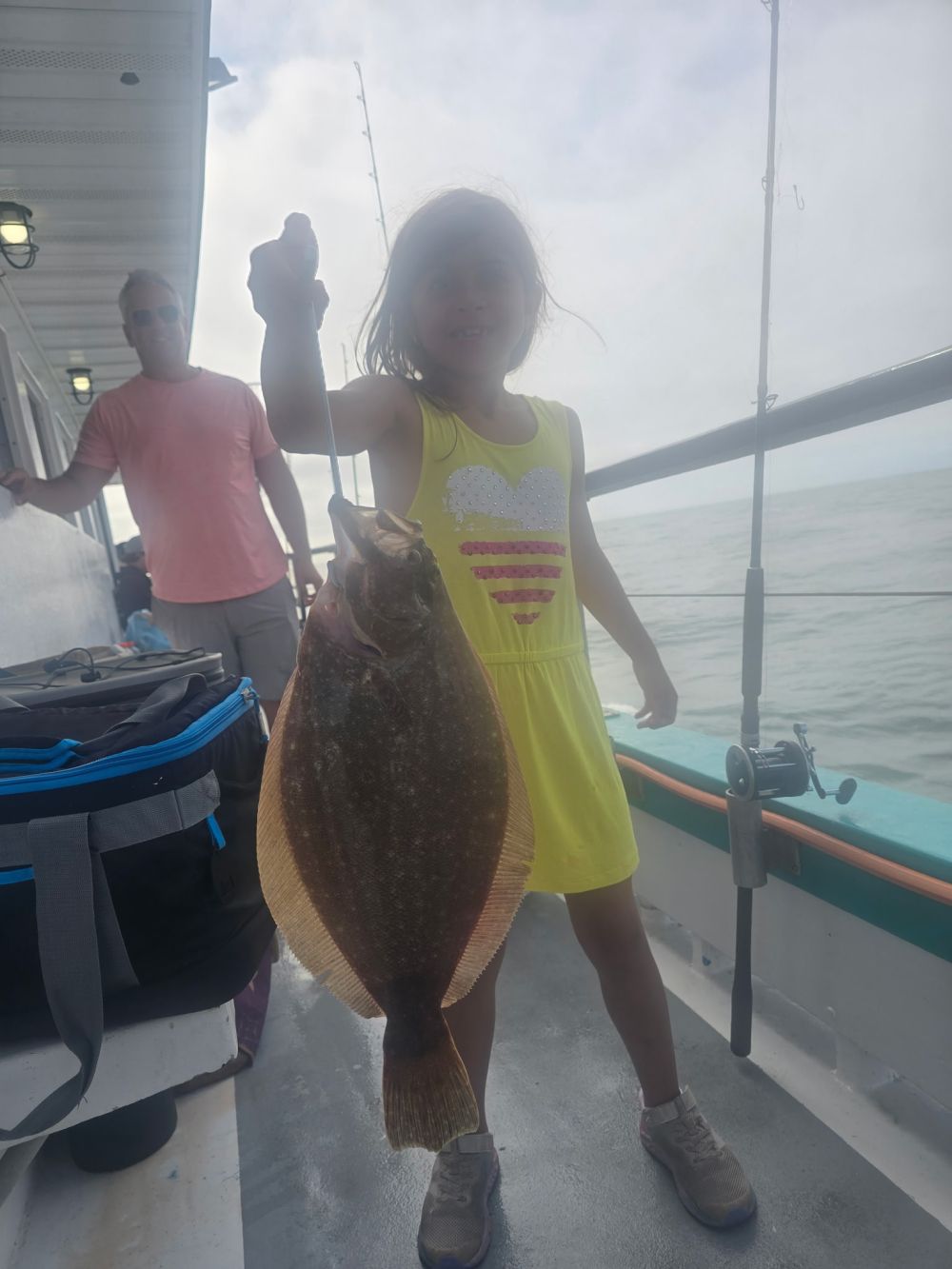 a man and a woman standing in front of a boat