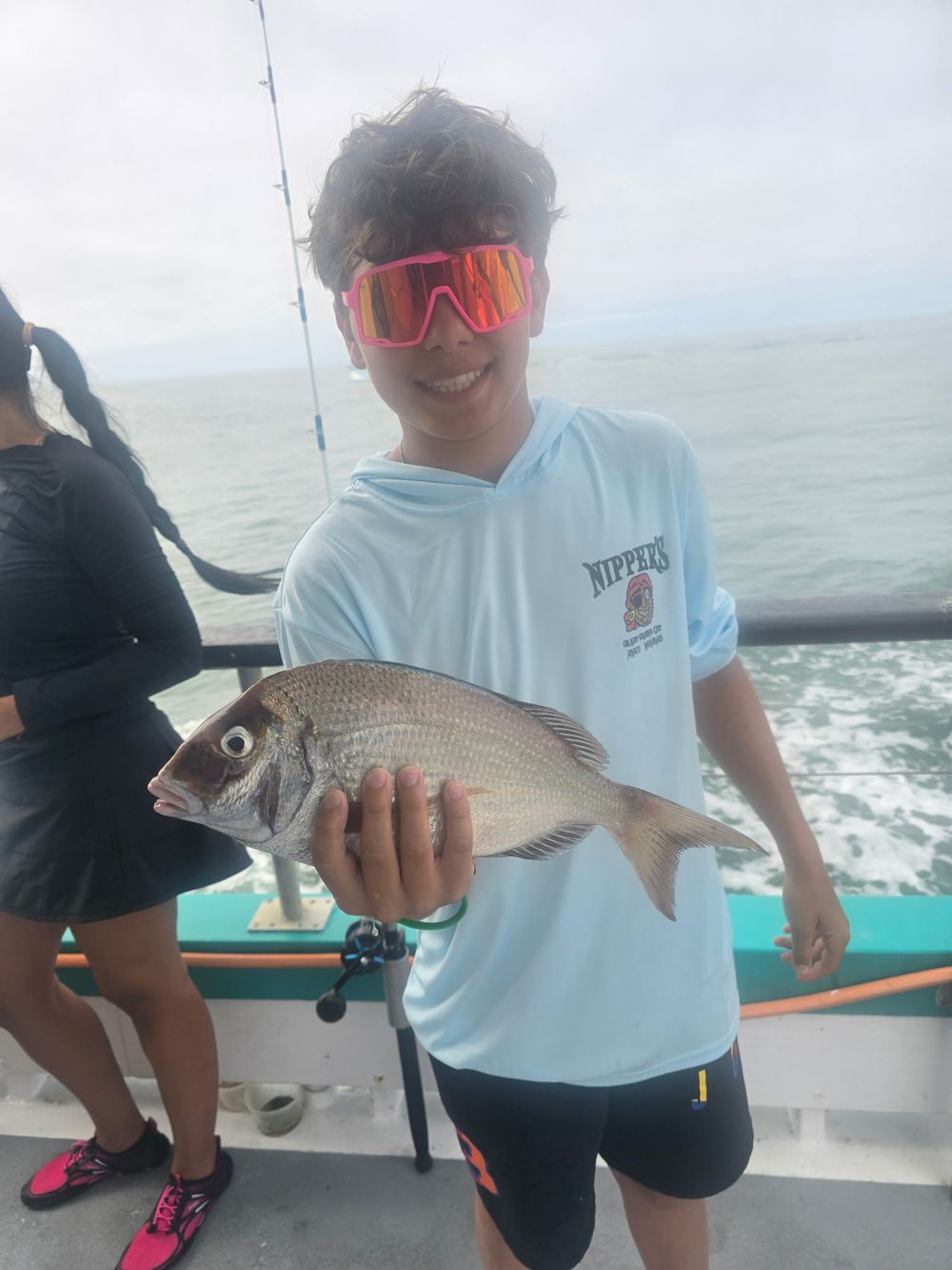 a woman holding a fish in the water