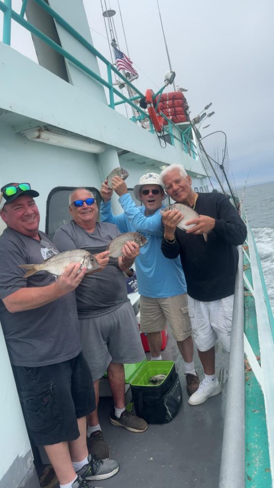 a group of people standing on a boat