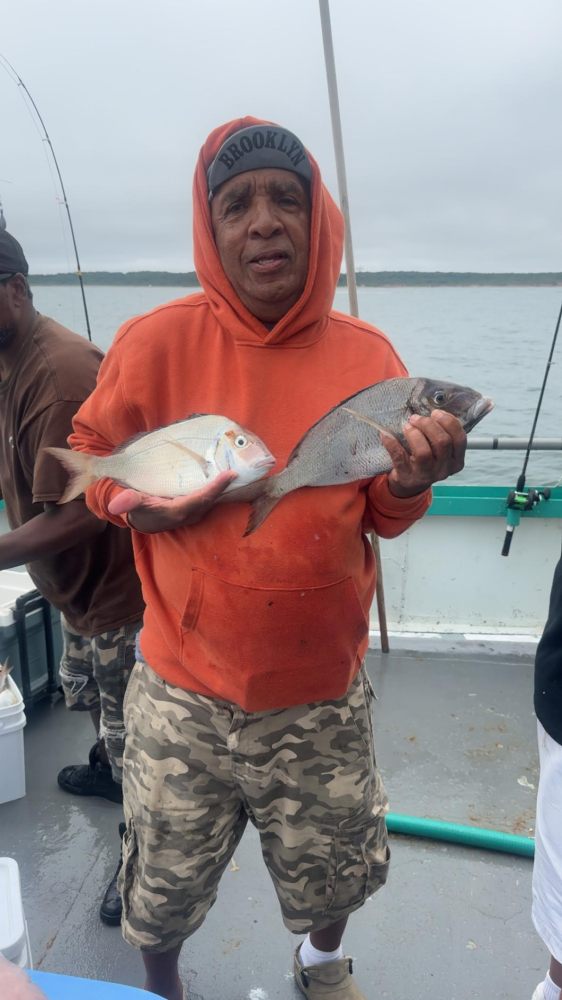 a person holding a fish in the water