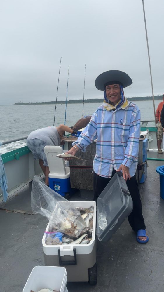 a man and a woman sitting on a boat in the water