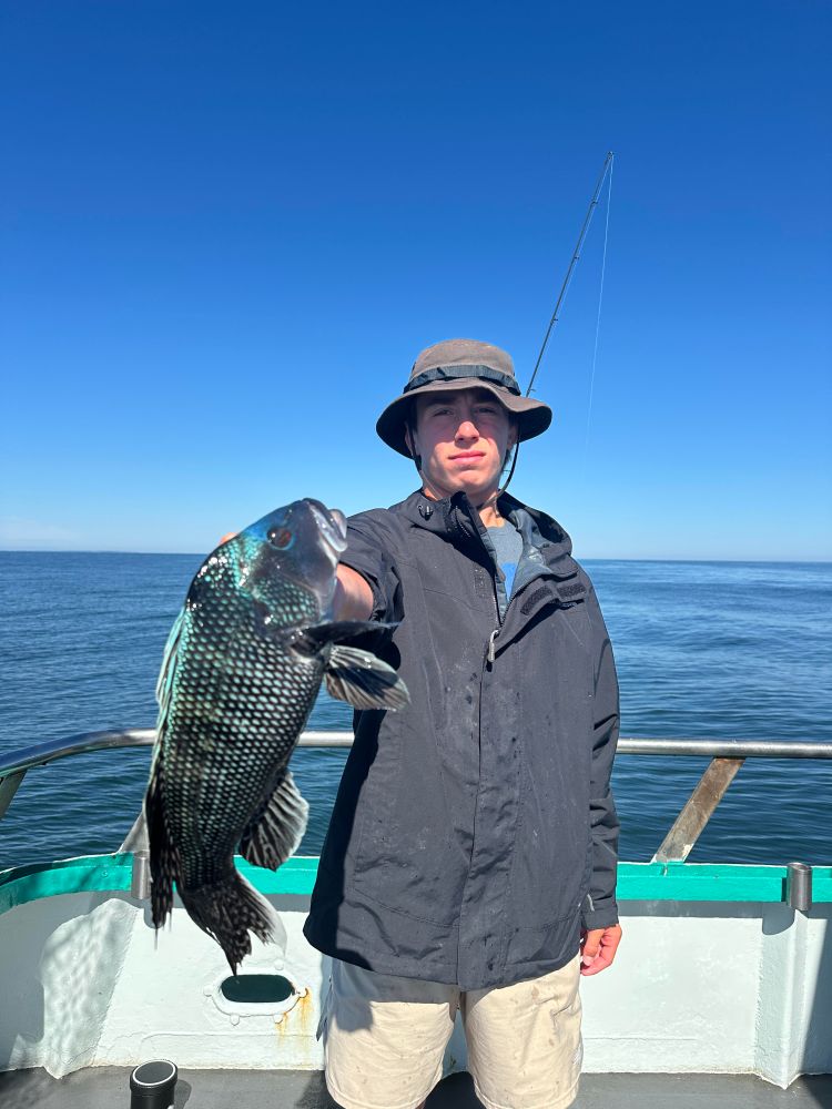 a man standing next to a body of water