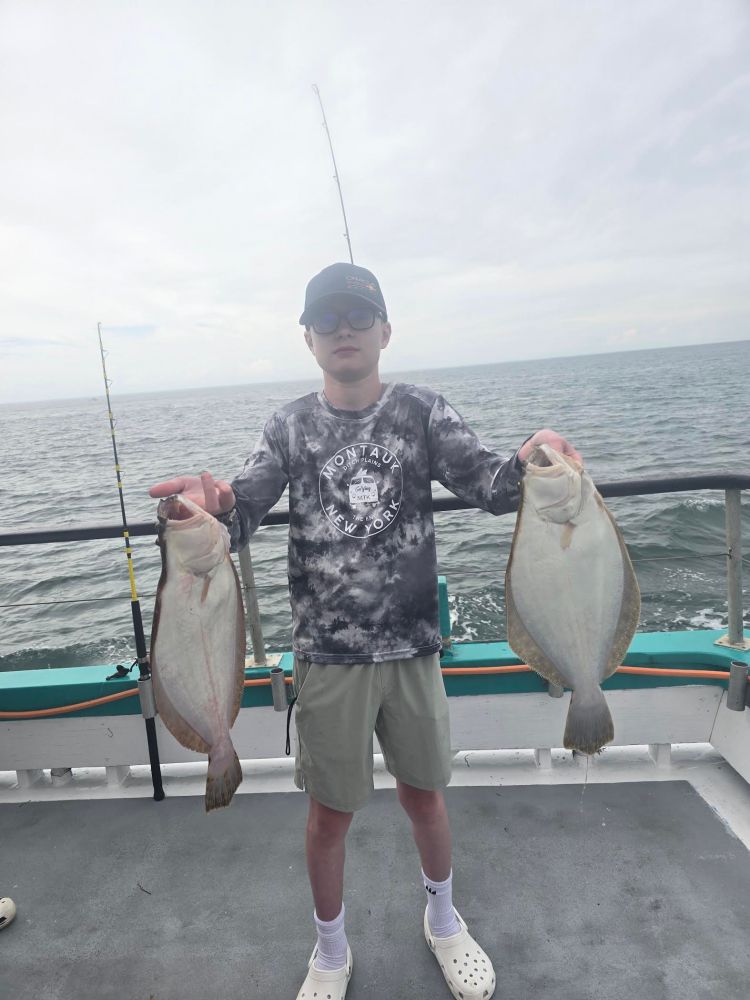 a man holding a fish in the water