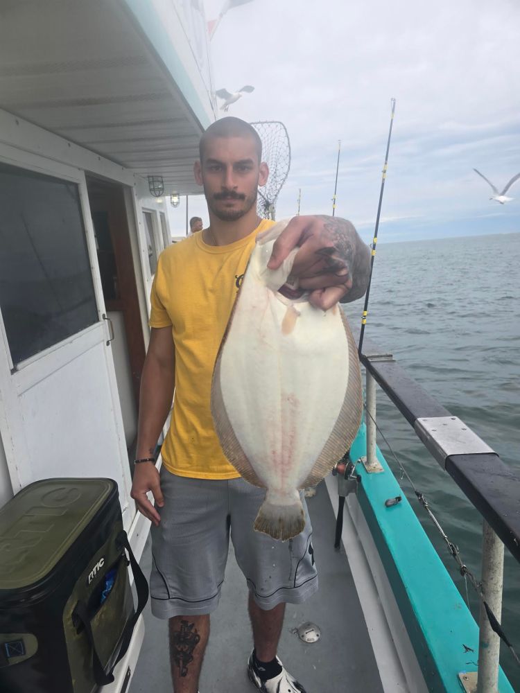 a man holding a fish