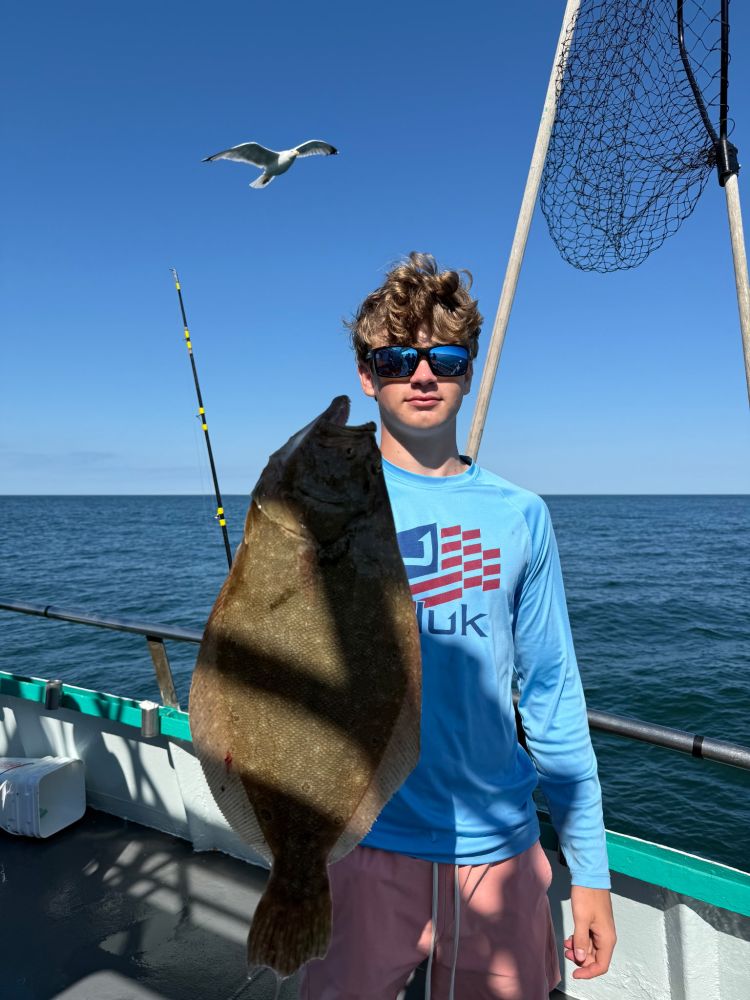a person holding a fish in the water