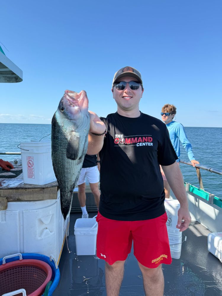 a person holding a fish in the water