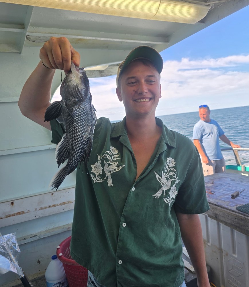 a person holding a fish in the water