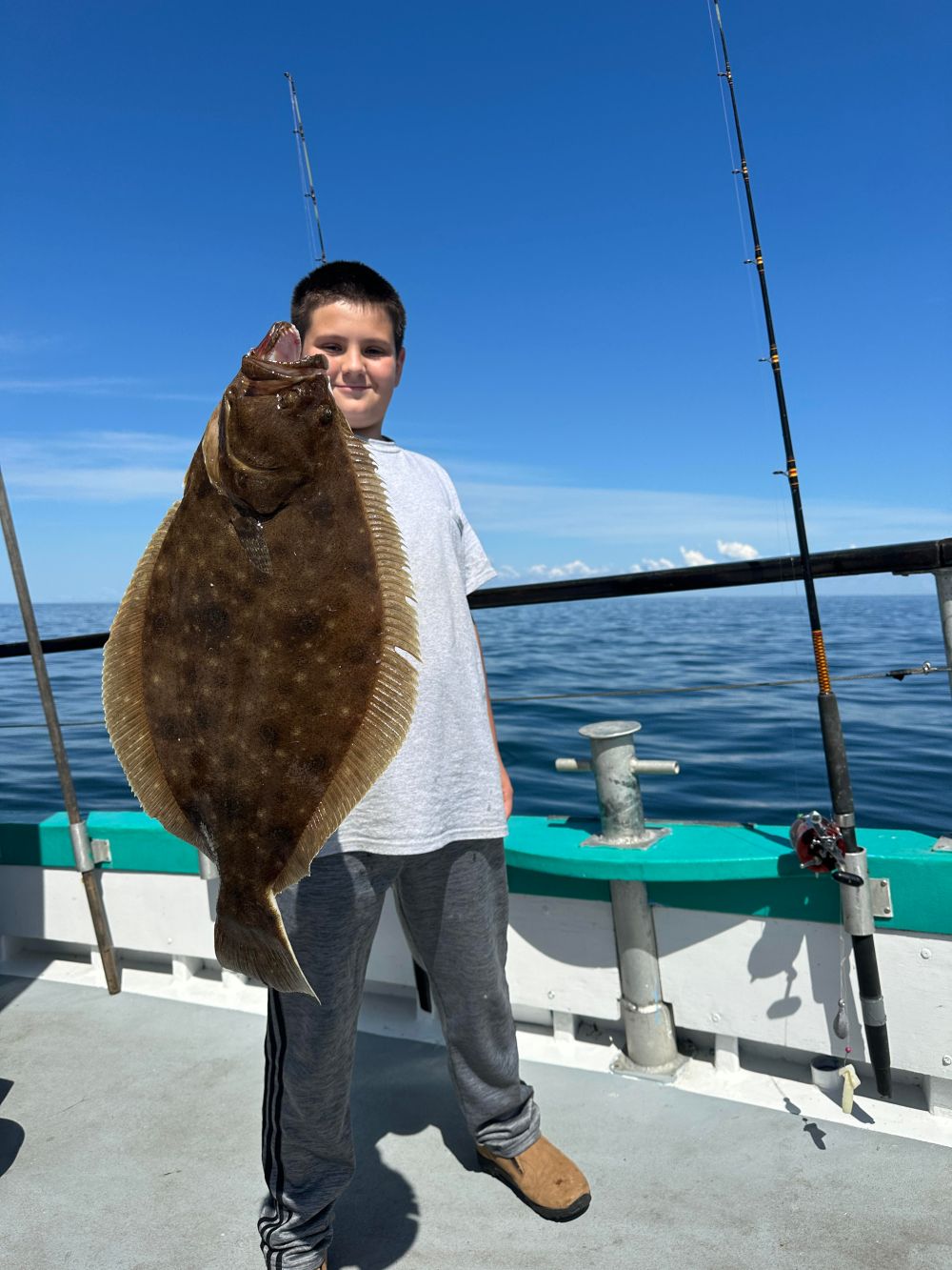 a statue of a person standing next to a body of water
