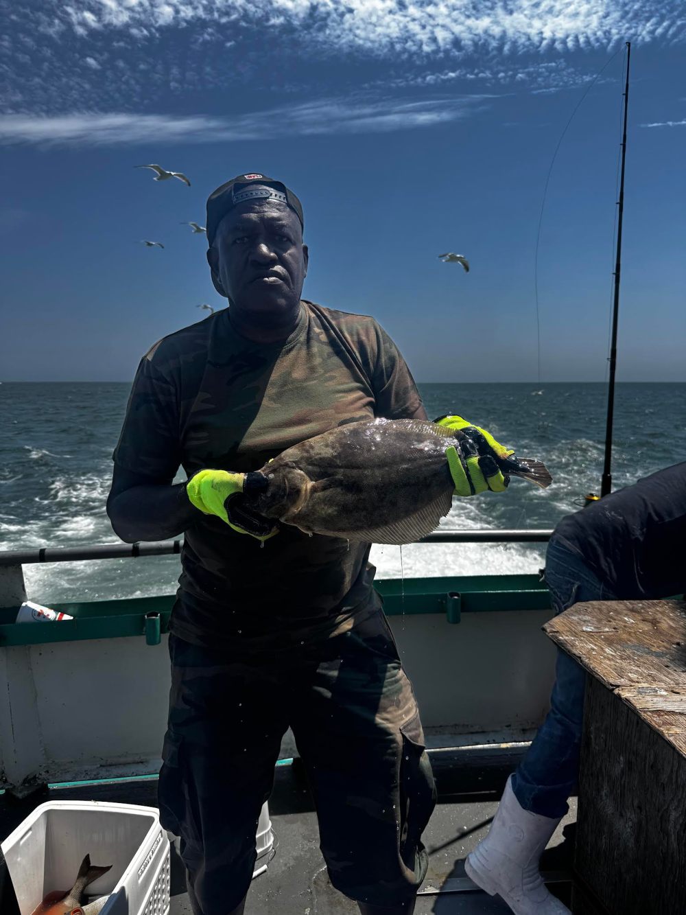a man standing next to a body of water