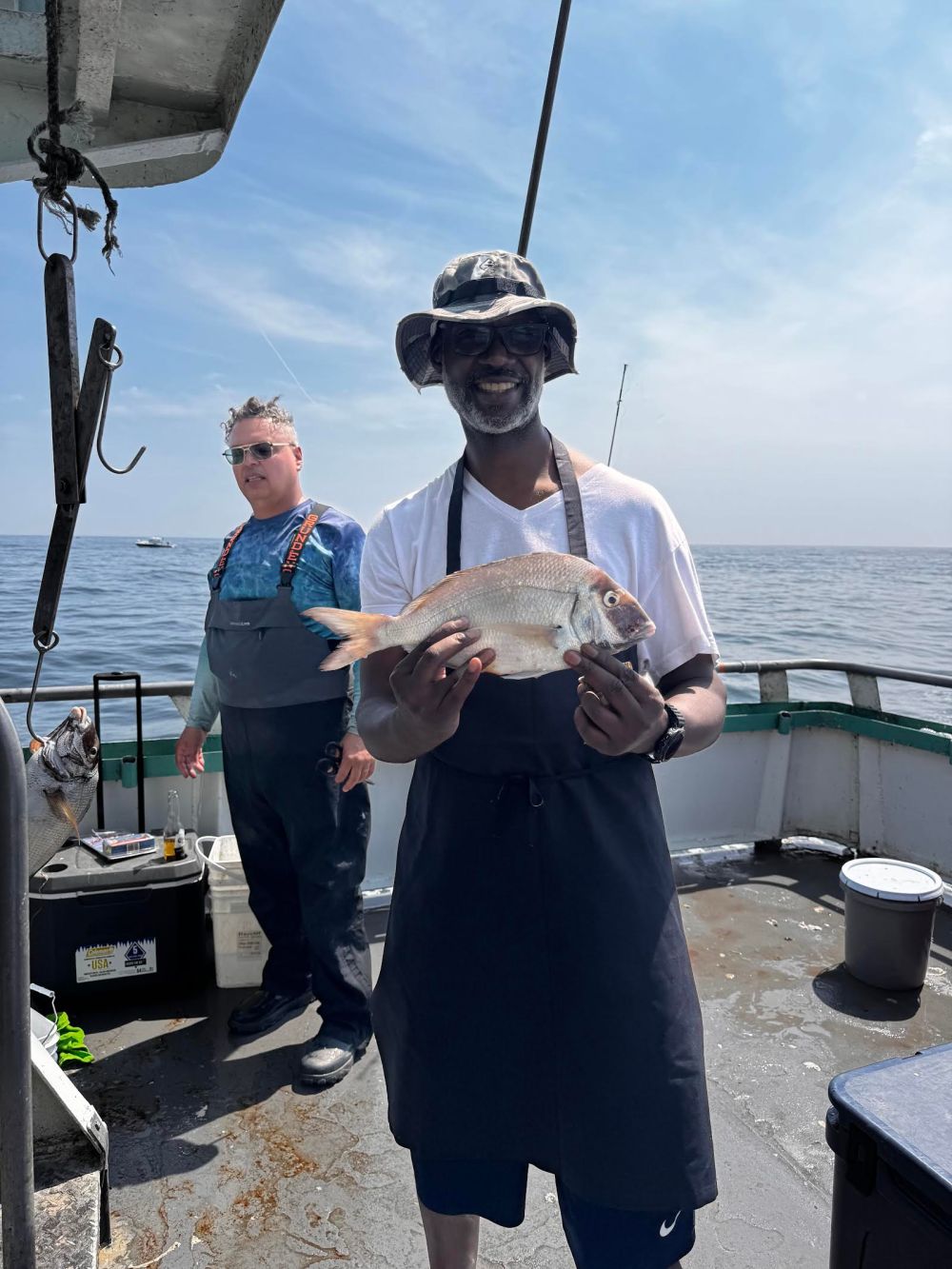 a person holding a fish in the water