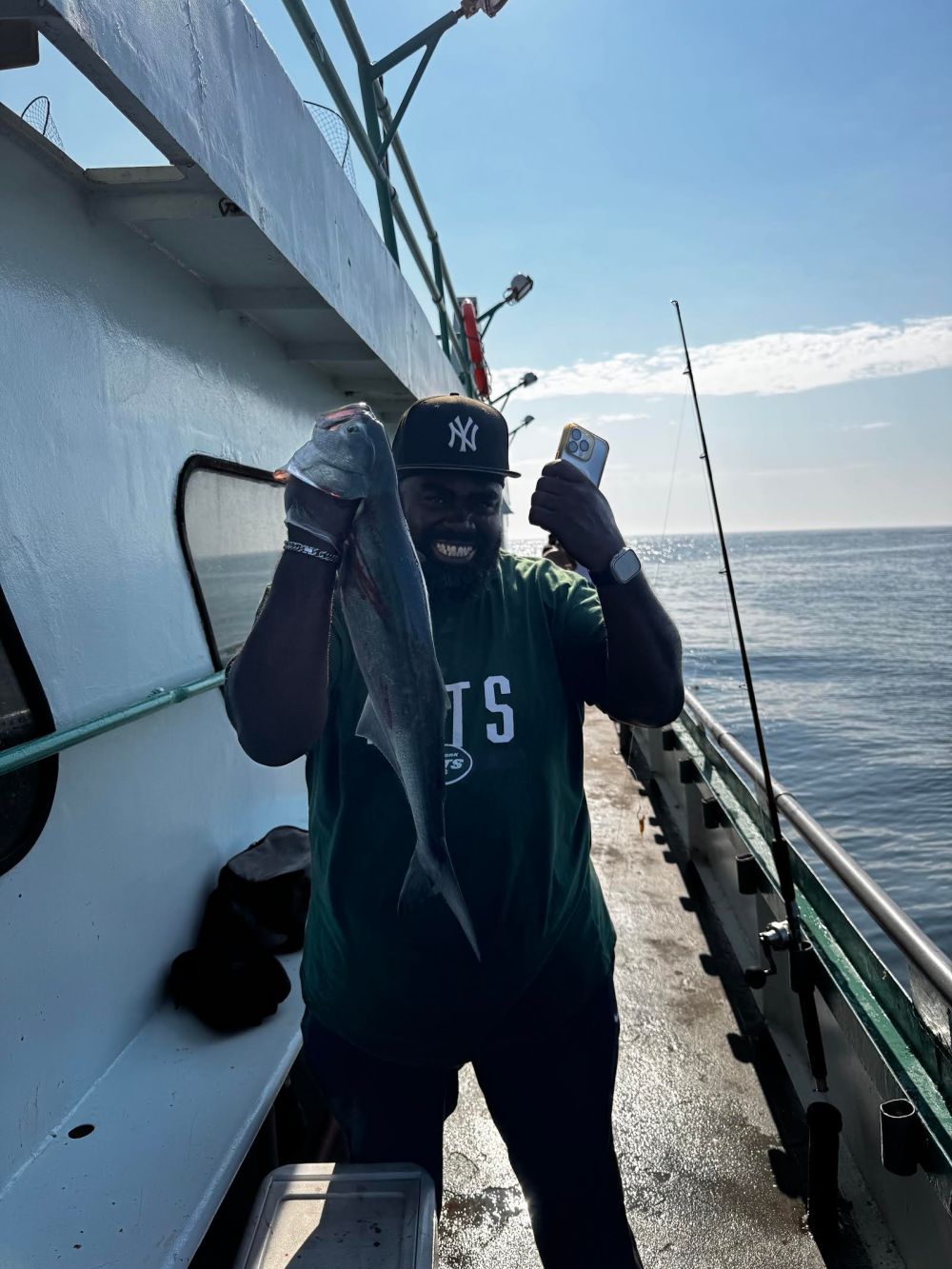 a man standing next to a body of water