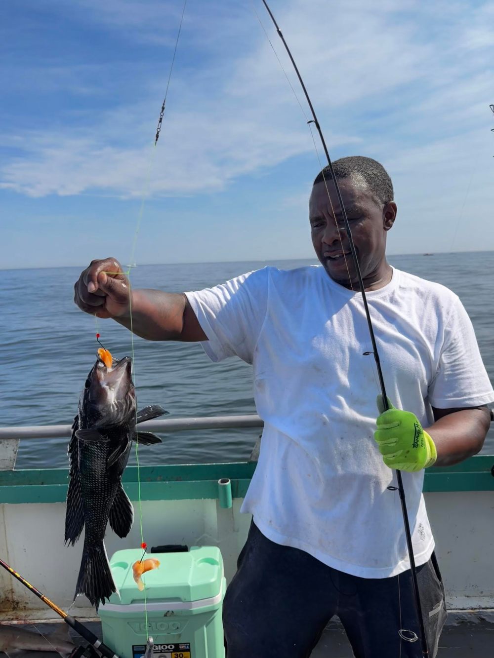 a man standing next to a body of water
