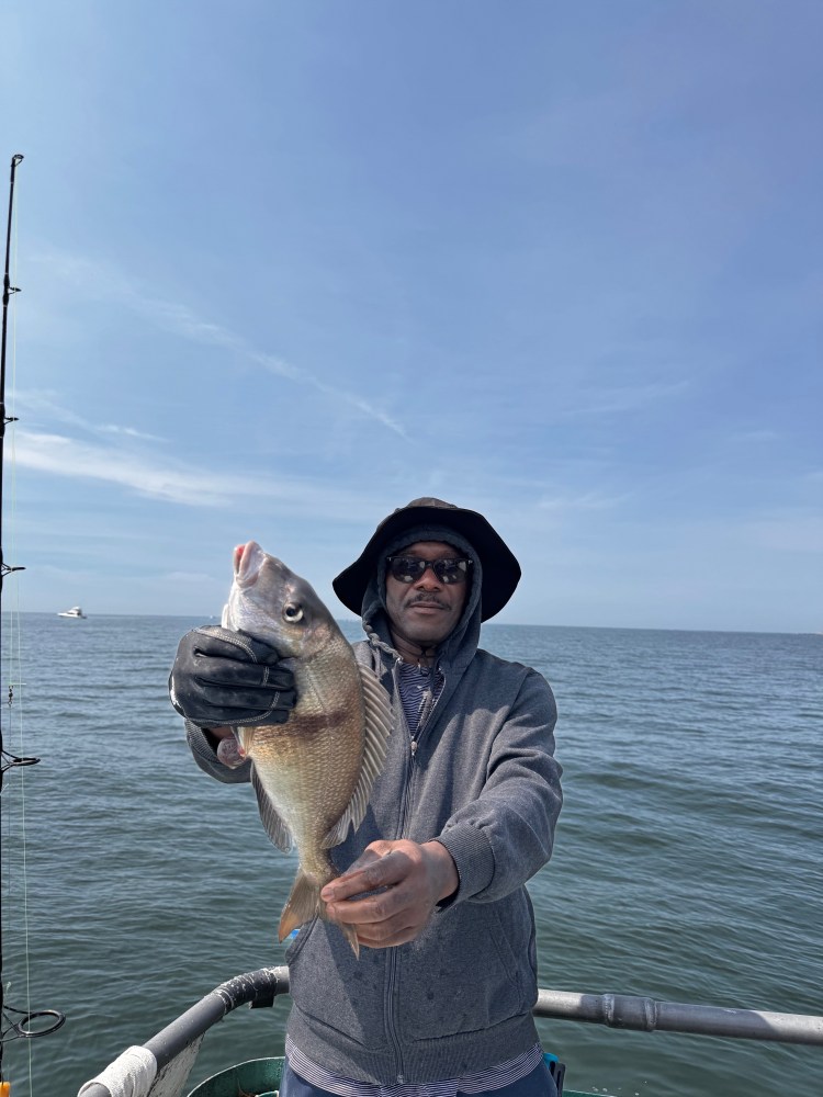 a man standing next to a body of water