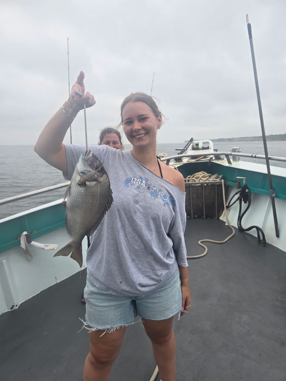 a person holding a fish in the water