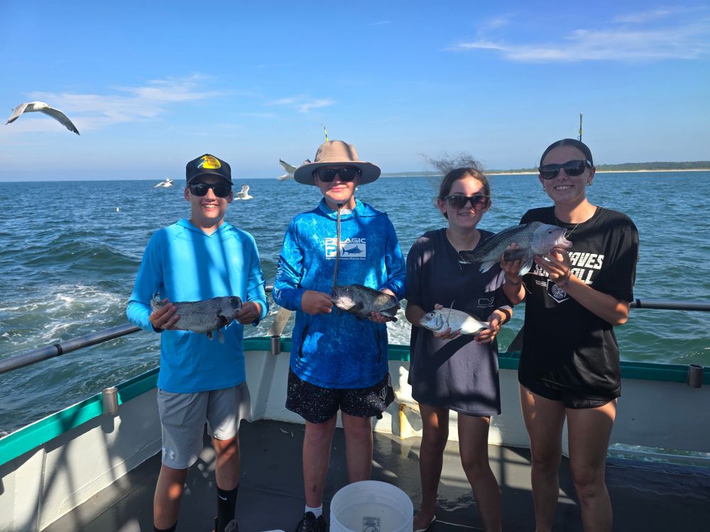 a group of people standing next to a body of water