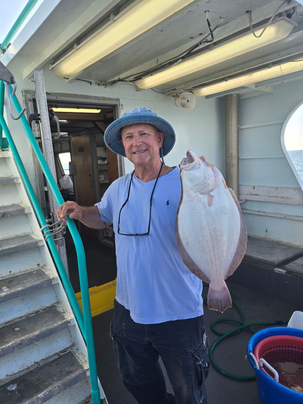 a man wearing a hat standing in front of a building