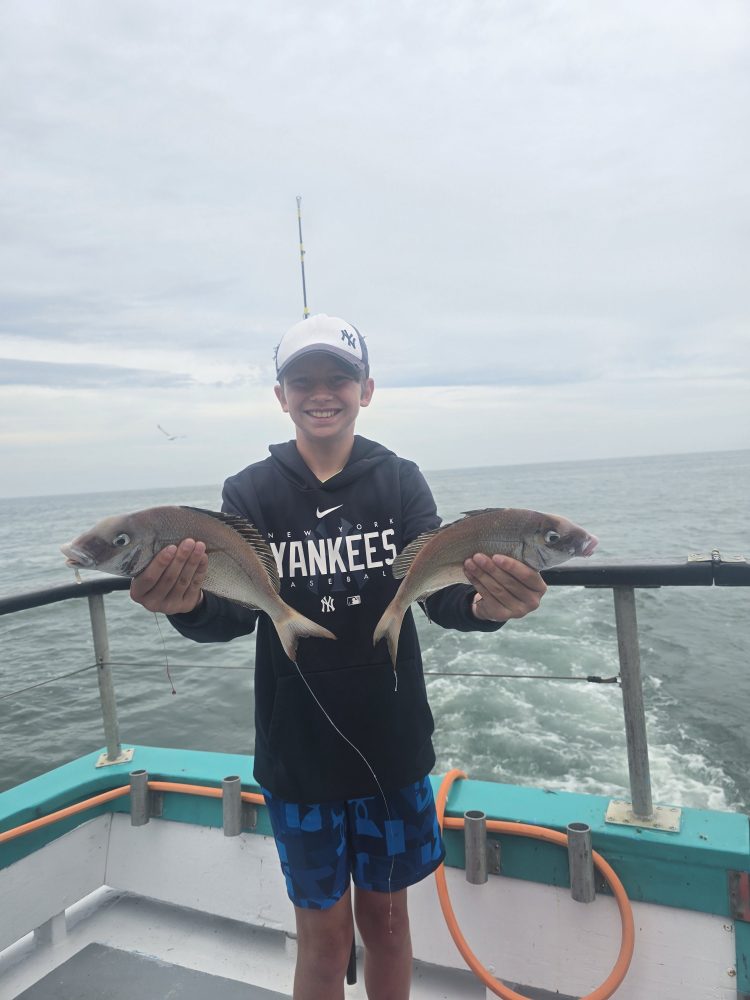 a person standing next to a body of water